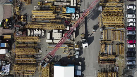 Construction-Crane-Loading-a-Truck,-Construction-Industrial-Storage,-Aerial-Top-Down