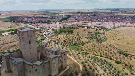 Belalcazar-castle-with-the-town-of-belalcazar,-cordoba,-spain-in-the-background,-aerial-view