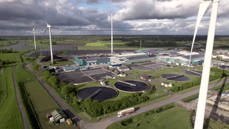 Clean-energy-wind-turbines-solar-panels-and-water-purifying-hub-in-agrarian-landscape-seen-from-above