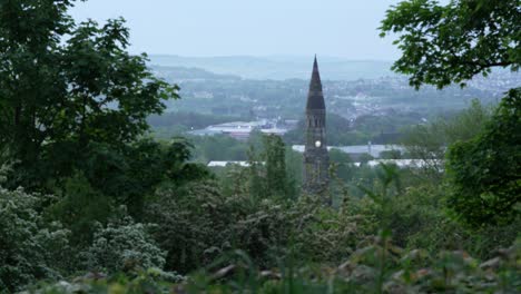Panning-Up-View-of-Town-with-Church-Spire-in-Early-Morning-Light-with-Foggy-Background