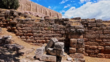 Hike-towards-Acropolis-ancient-buildings,-Greece-scattered-fortress-wall,-Athens-landmark