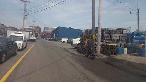 Union-Pier-Portland-a-worker-rides-an-electric-bike-during-a-break-from-packing-fish