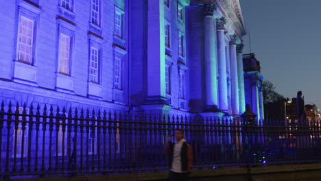 Profile-view-of-Trinity-College-during-nighttime-illuminated-with-blue-light-in-Dublin,-Ireland