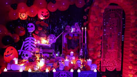 Spooky-Day-of-Dead-altar-with-decorations,-candles-and-purple-light