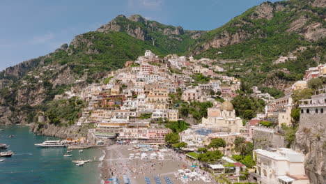 Aerial:-Flying-over-Positano-on-the-Amalfi-coast-in-Campania,-Italy-on-a-Sunny-day