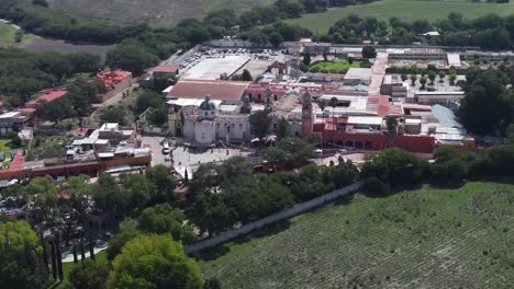 Atotonilco,-mexico,-showcasing-historic-buildings-and-lush-greenery,-aerial-view