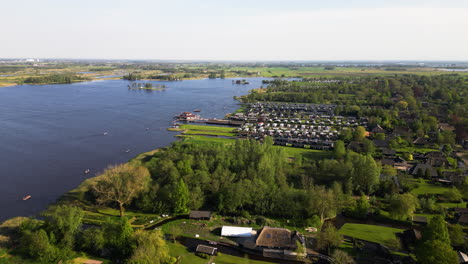 Green-and-vibrant-landscape-with-township-of-Giethoorn,-aerial-view