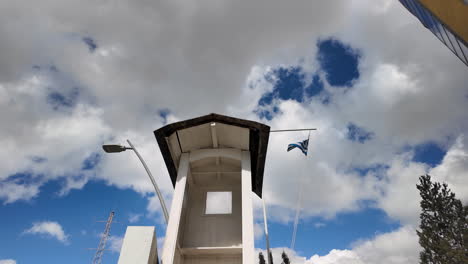 A-low-angle-view-of-a-guard-tower-with-the-Greek-flag-in-Nicosia,-Cyprus