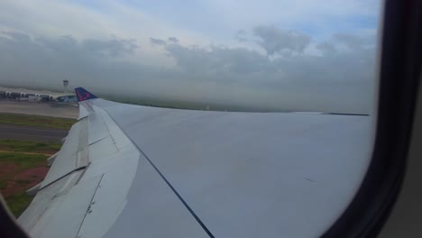 View-of-Blaise-Diagne-International-airport-terminal-aerodrome-through-window-of-airplane-taking-off-in-Senegal