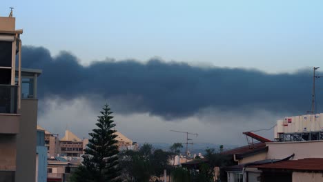 Time-lapse-of-a-thick-black-smoke,-after-a-missile-attack-in-Israel,-wildfire-burn,-trees-in-the-background,-4k-video