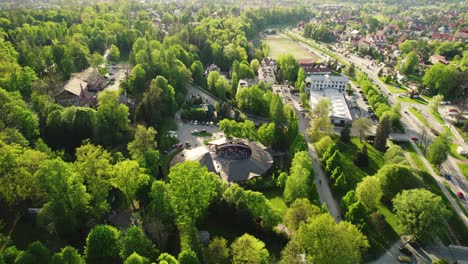 Stunning-Outdoor-Concert-Venue-Surrounded-by-Trees,-Aerial-Sunset-4k