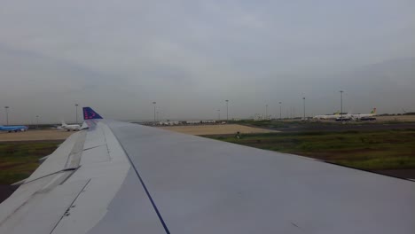 Airliner-window-view-while-taxiing-at-Blaise-Diagne-International-airport,-Senegal