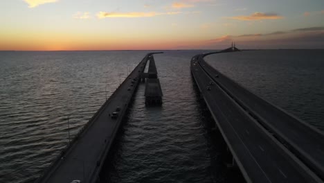 Sunset-aerial-over-Tampa-Bay-Sunshine-State-Skyway-and-State-Park-fishing-Pier,-Florida
