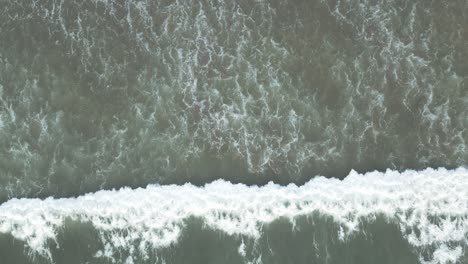 Drone-Flying-Above-Sea-Waves-at-Sandy-Beach---Bird's-Eye-View-Aerial-Footage