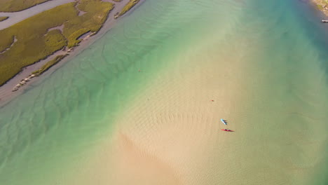 Recreational-kayakers-explore-sand-bank-in-scenic-Goukou-estuarine-river,-aerial