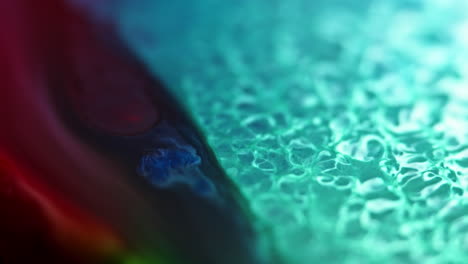 Vibrant-ink-flows-in-water-creating-a-mesmerizing-blend-of-colors-and-textures,-macro-shot