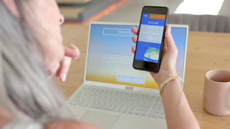 Mature-Caucasian-woman-holding-smartphone,-showing-travel-booking