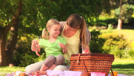 Mother-with-her-daughter-eating-watermelon-