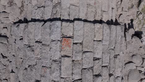 Ascending-flight-with-a-top-down-view,-appreciating-the-masonry-carved-into-rectangles-that-form-the-vault-of-the-ruined-hermitage-of-San-Pedro,-14th-century,-ending-the-filming-with-turns