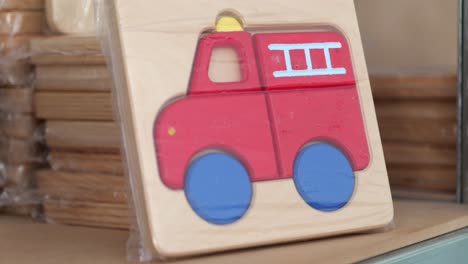 Small-handmade-wooden-puzzle-of-a-red-fire-truck-for-toddlers