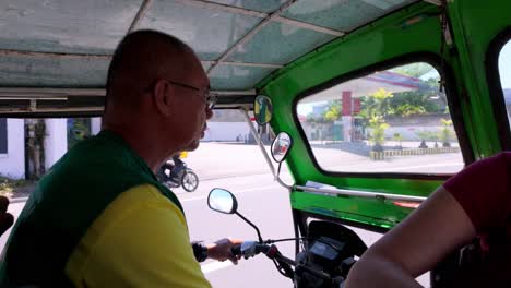 Philippines,-Dumaguete:-The-video-captures-a-shot-of-our-friendly-tuk-tuk-driver-who-took-us-from-Dumaguete-port-to-our-hotel