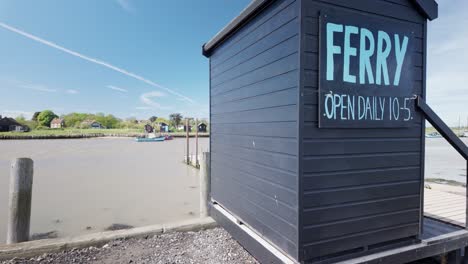 Wooden-shed-times-information,-Walberswick-ferry-River-Blyth-crossing