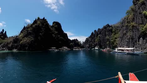 Philippines,-Coron:-The-video-captures-the-approach-to-one-of-the-many-lagoons-off-the-island,-showcasing-cliffs-and-the-impressive-blue-water