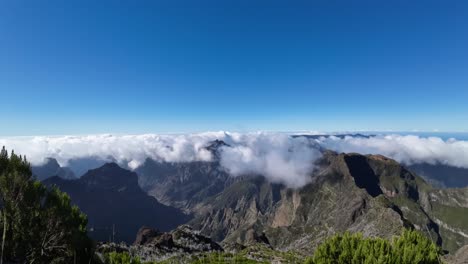 Time-lapse-of-clouds-flowing-over-the-mountain-range-on-a-sunny-day-on-an-island