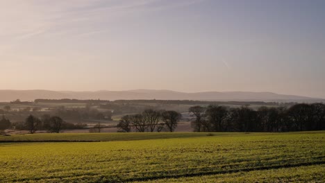 Wide-shot-of-golden-sunrise-in-a-rural-area-of-Scotland-in-winter-in-Perth-Shire,-United-Kingdom