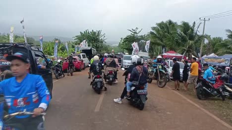 Training-with-motocross-dirt-bike-riders-on-a-village-road-on-a-sunny-day,-Garut,-West-Java,-Indonesia