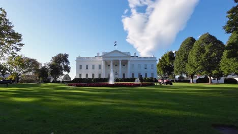 White-house-on-a-sunny-day-with-some-green-trees,-green-grass-and-clear-sky