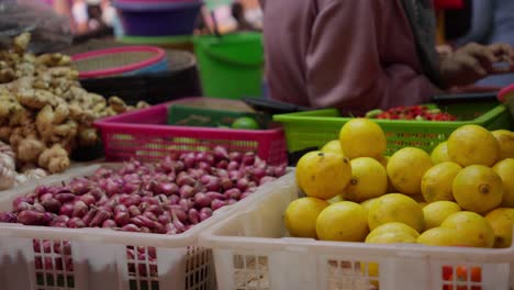 Vibrante-Puesto-En-El-Mercado-Indonesio-Con-Limones-Frescos,-Chalotes,-Ajo-Y-Pimientos-Rojos