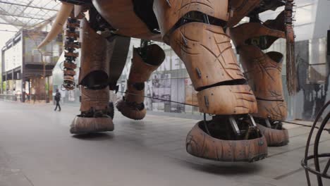 Close-up-of-the-mechanical-elephant-from-the-island-of-Nantes-with-visitors-on-its-back