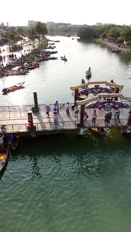 Boats-on-the-Thu-Bon-River,-Hoi-An,-Vietnam,-vertical-aerial-view