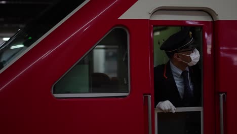 Japanese-train-operator-checking-the-time-at-the-Tokyo-subway-station