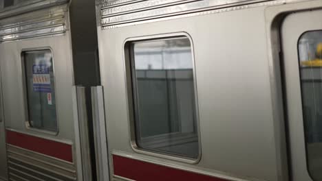 The-local-train-arrives-at-the-train-station-platform-in-Japan,-tokyo