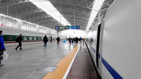 China,-Nanjing:-The-video-captures-walking-on-the-platform-of-Nanjing-train-station-to-catch-the-high-speed-train-to-Shanghai,-showcasing-the-platform-and-the-train