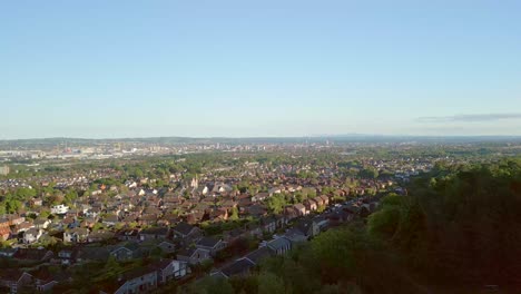 Aerial-shot-of-Belfas-City,-Northern-Ireland,-UK-from-the-perspective-of-Belfast-Castle-in-North-Belfast-on-a-sunny-evening