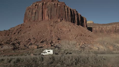 Camper-driving-on-Park-Highway-in-Indian-Creek-Climbing-area-in-Utah,-USA