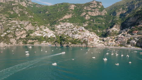 Aerial:-Slow-panning-drone-shot-of-Positano-in-Amalfi-coast,-Italy-during-a-sunny-day