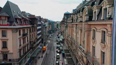 Jib-down-of-beautiful-street-in-the-historical-city-center-of-Geneva,-Switzerland