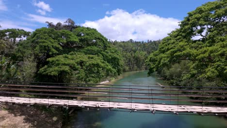 Philippines,-Bohol:-The-video-captures-the-iconic-bamboo-bridge-over-the-Loboc-River,-showcasing-its-unique-structure-and-scenic-surroundings