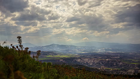 Panorama-timelapse-of-greek-countryside-and-mountains,-sunbeams-through-clouds