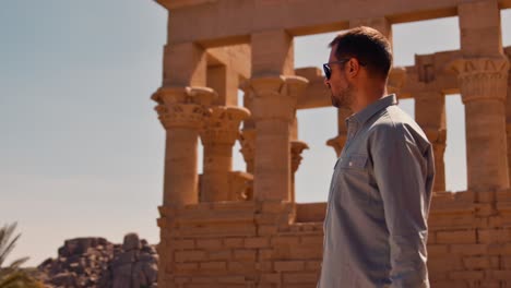 Turista-Masculino-Explorando-La-Arquitectura-Egipcia-Antigua-En-El-Quiosco-De-Trajano,-Isla-De-Philae