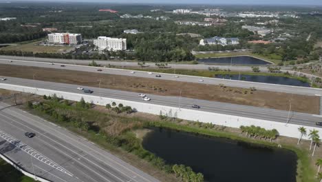 Aerial-view-of-highway-and-ramp-with-traffic-to-an-upscale-mall-located-in-Sarasota,-Florida