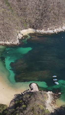 Vertical-aerial-view-of-La-Entrega-Beach,-coral-reefs,-Huatulco,-Oaxaca