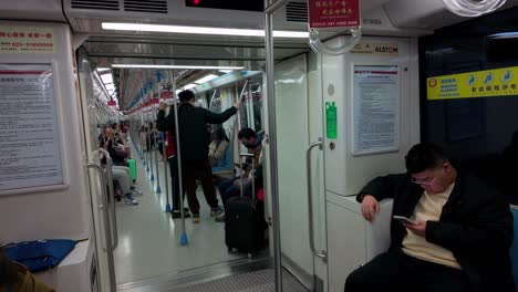 China,-Nanjing:-The-video-captures-a-view-from-inside-a-metro-carriage,-showcasing-the-interior-and-the-outside-scenery-of-Nanjing