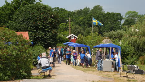 Volunteers-Prepare-Outdoor-Market-During-National-Holiday,-Sweden,-Slow-motion
