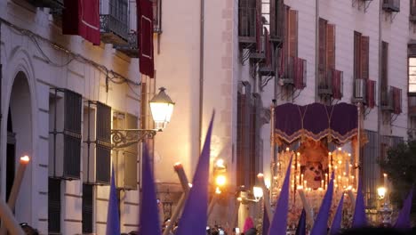 A-"paso"-float-with-a-statue-of-the-Virgin-Mary-rocks-gently-amongst-the-capirotes-above-the-crowd-as-it-is-carried-through-Sacramento-Street-in-Madrid-during-the-Easter-celebrations