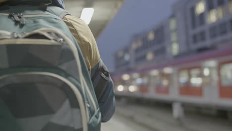 Commuters-wait-as-a-Deutsche-Bahn-train-arrives-at-station,-early-evening